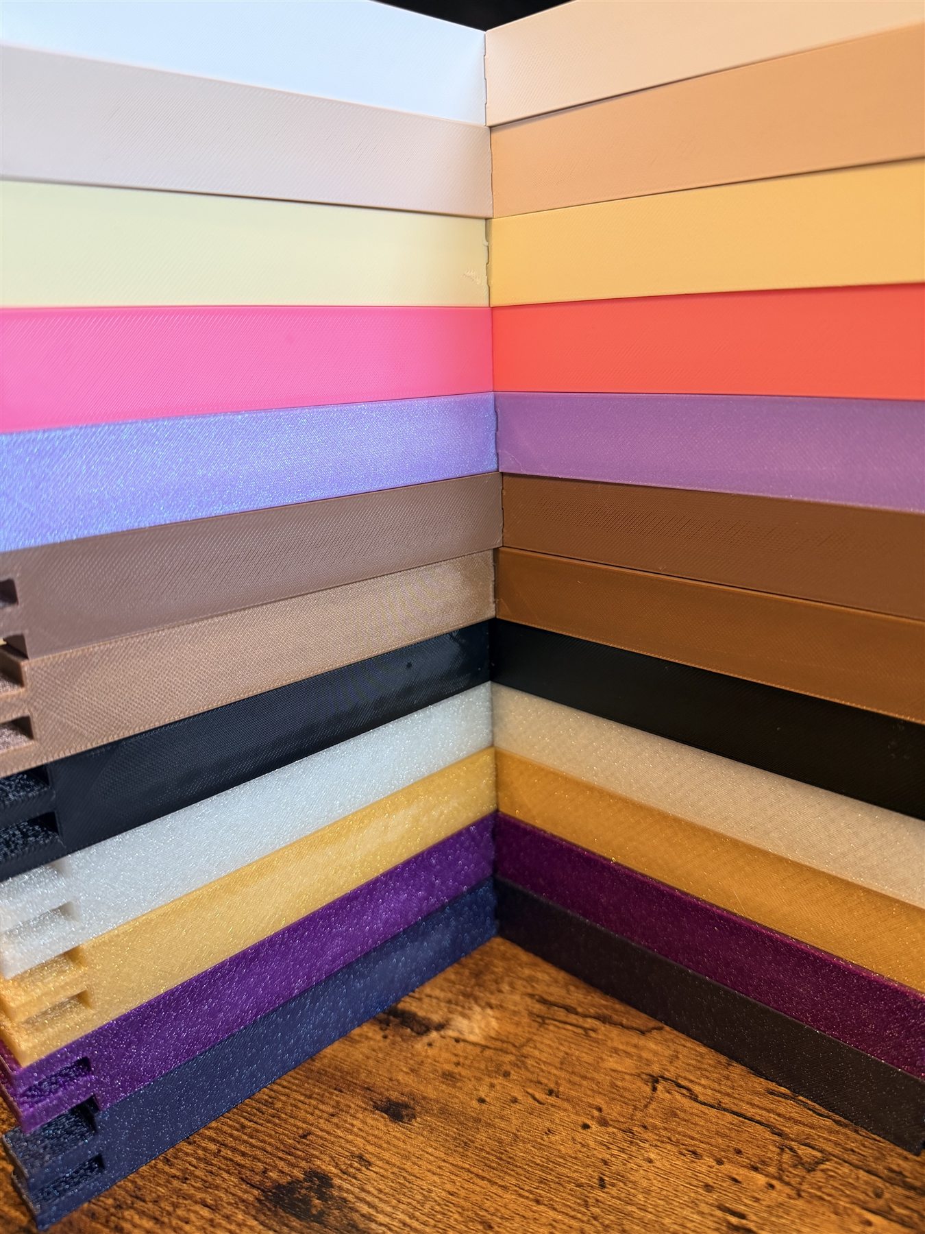 Twelve Denton Curio Co stretcher bar colors stacked into a frame corner
