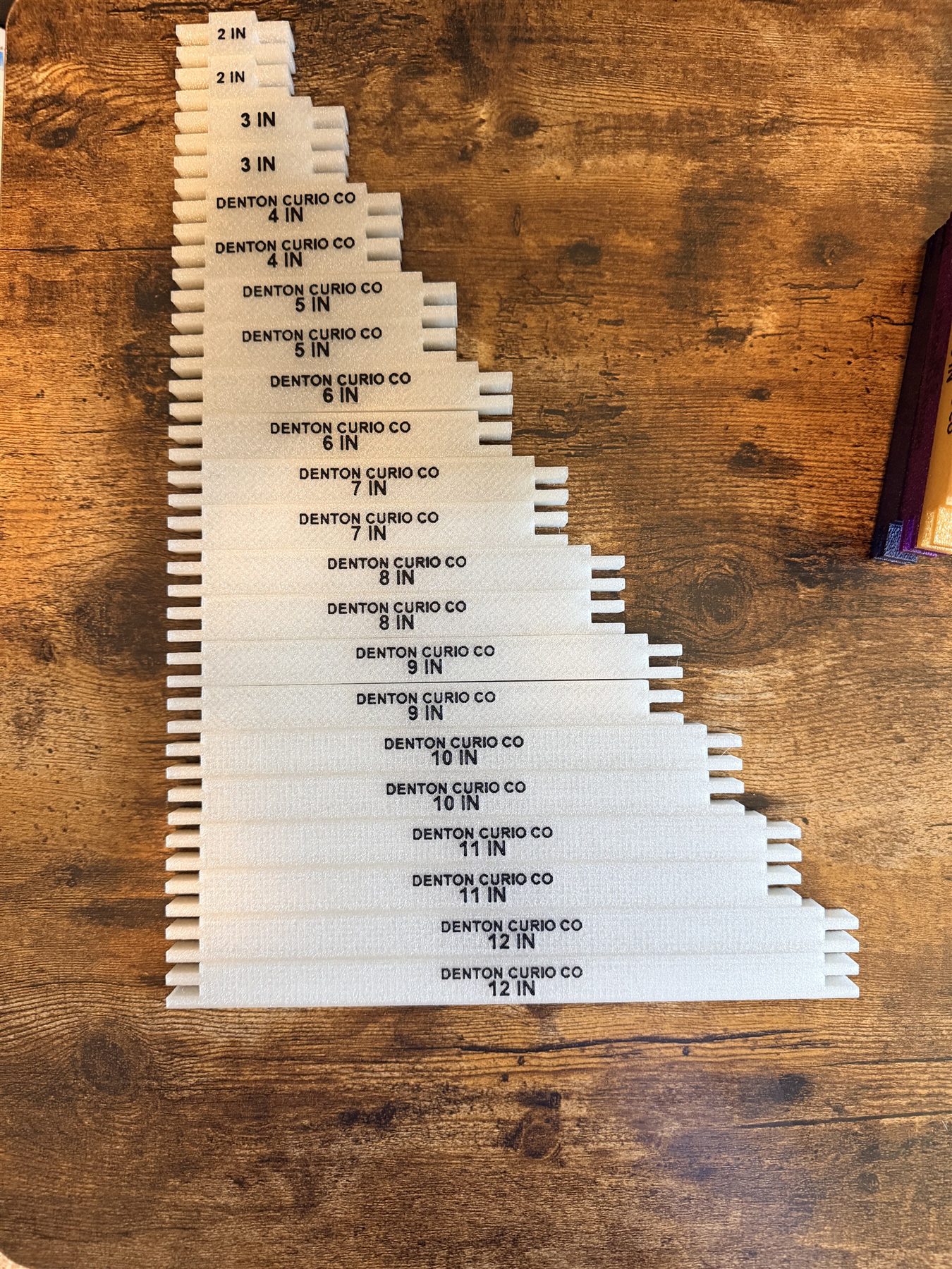 Pairs of silver stretcher bars arranged from 2 through 12 inches for size comparison
